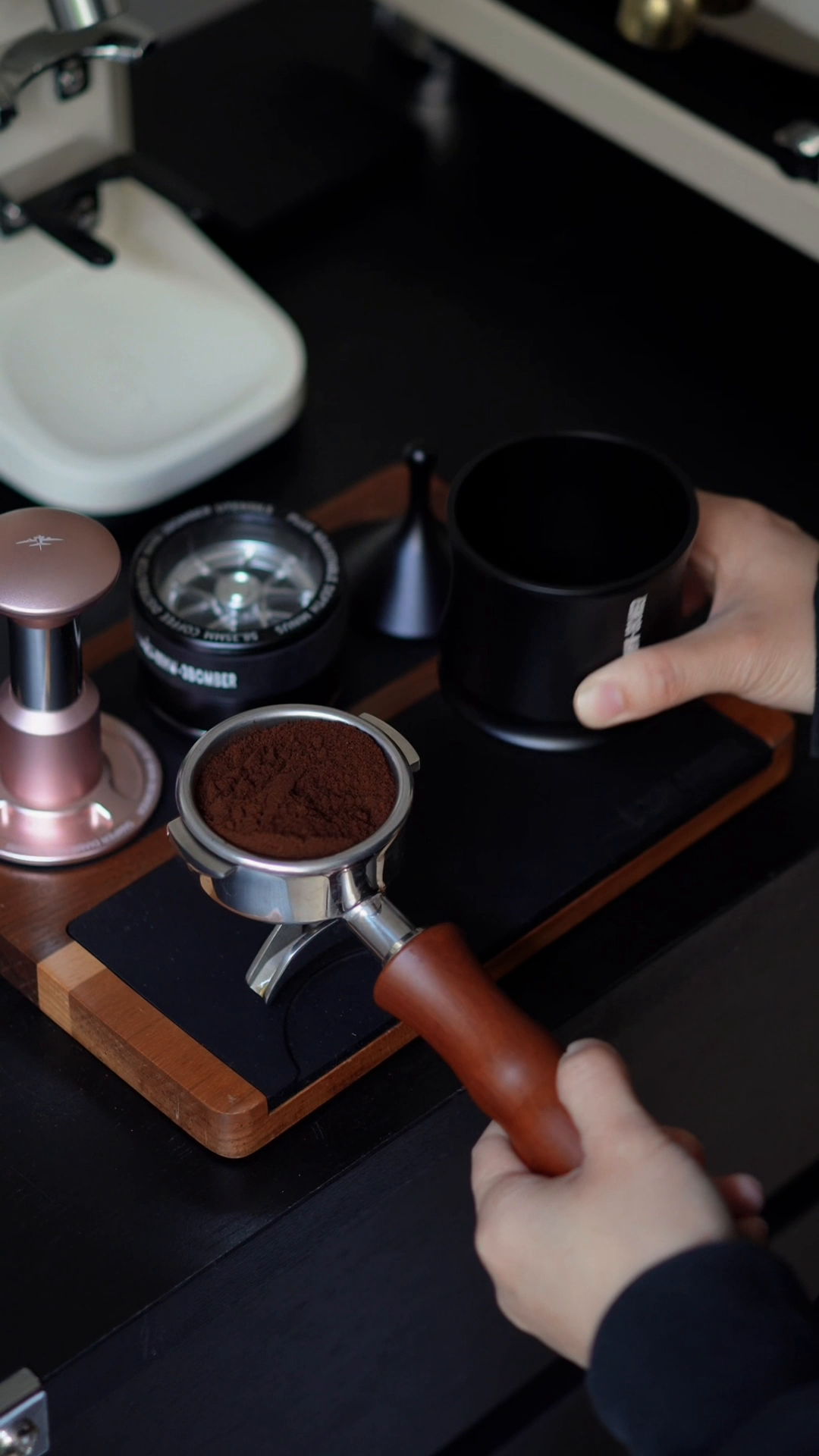 MHW-3BOMBER DR7031B Titanium Black FlowLight cup lifted after transferring coffee grounds into a portafilter; other tools not included