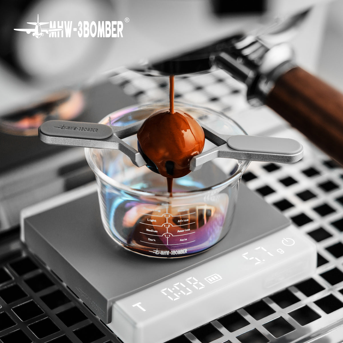 MHW-3BOMBER IH6659S 30 mm espresso chilling ball: angled close-up of espresso brewing over a graduated glass; other pictured equipment and props are not included.