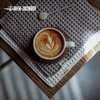 MHW-3BOMBER C5080W Beige White 280 ml latte cup viewed from above with latte art; spoon and wooden coaster are photo props.