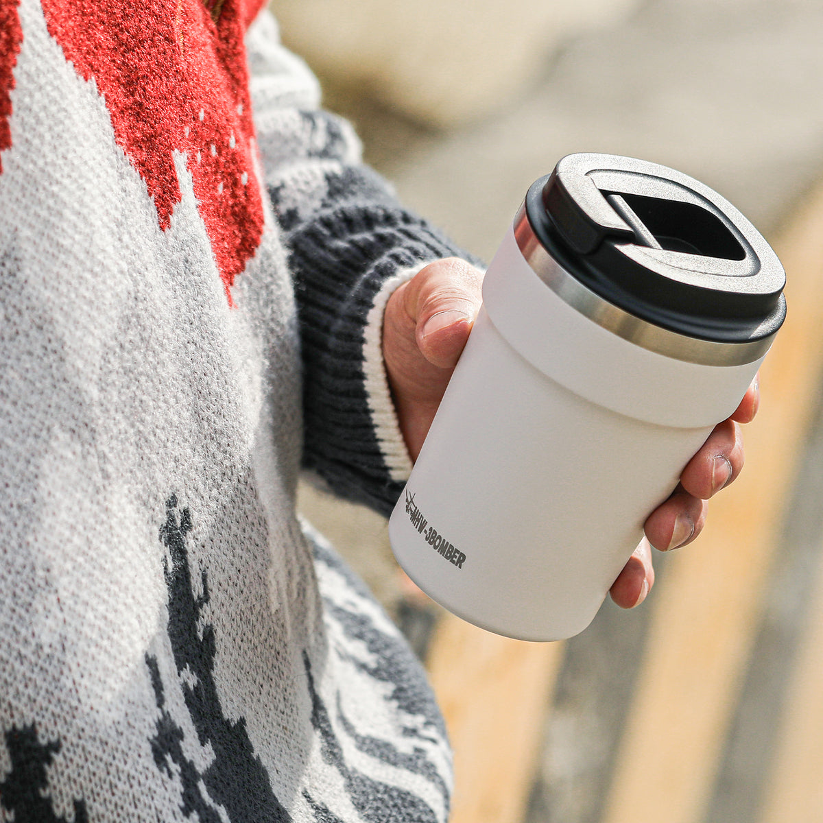 MHW-3BOMBER M5716W Cooki 360 ml travel cup: beige-white cup with its hinged lid open outdoors; other pictured equipment and props are not included.