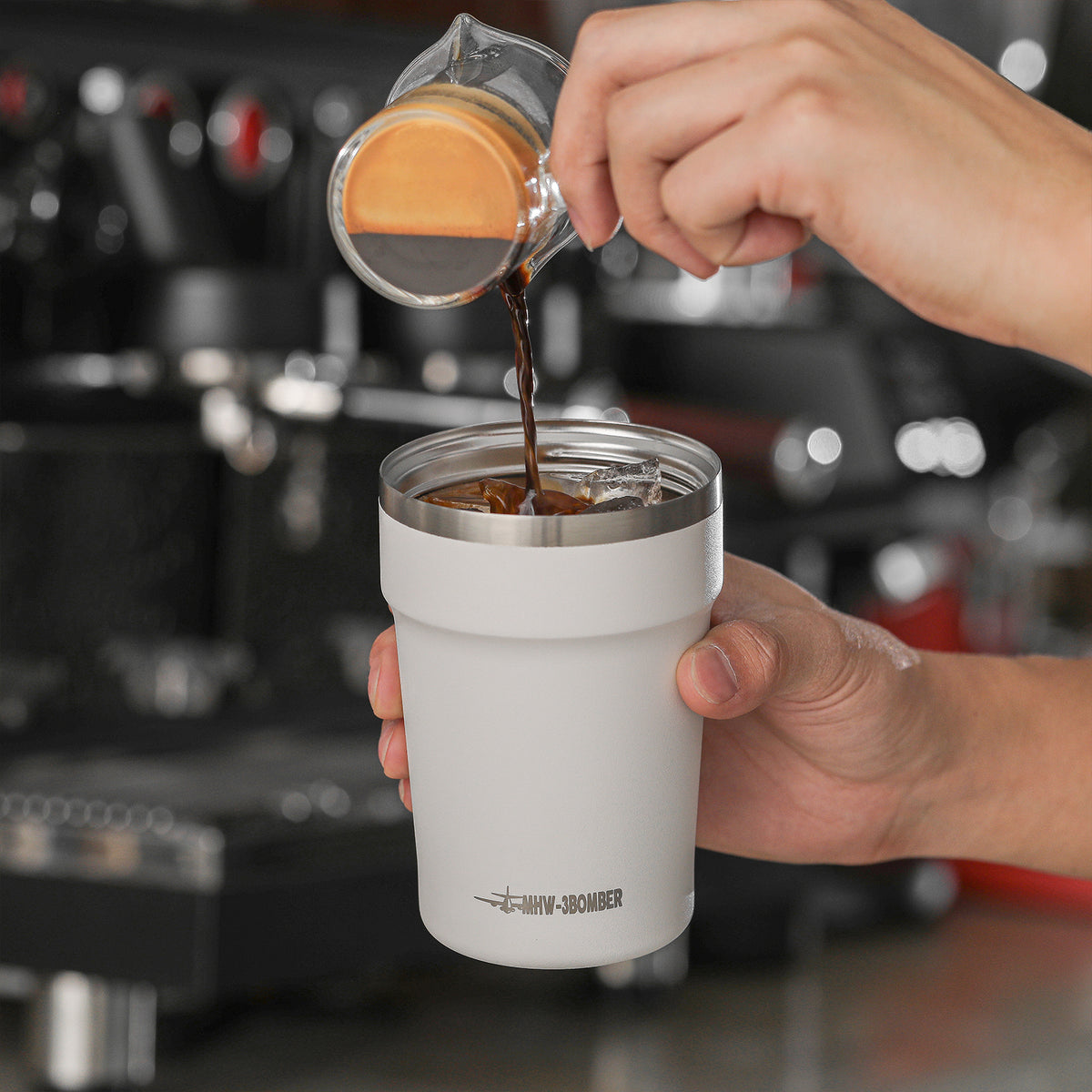 MHW-3BOMBER M5716W beige-white Cooki 360 ml travel cup being filled with coffee beside an espresso machine; other pictured equipment and props are not included.