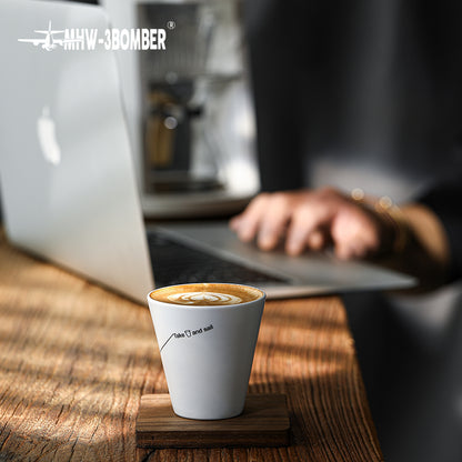 MHW-3BOMBER Winter Cup C5090W Morning Mist White with latte on a desk