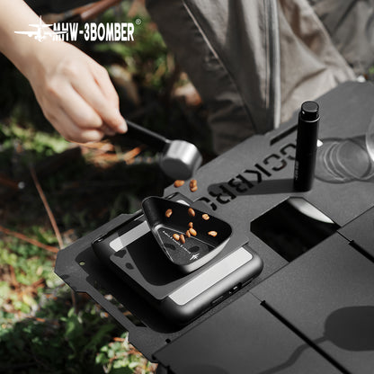 MHW-3BOMBER P6562B small black BeanBoat tray receiving beans outdoors; scale, spoon and other accessories are demonstration props