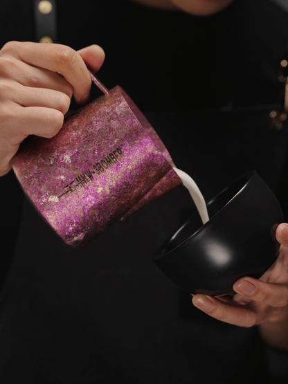 MHW-3BOMBER P6635R Spark 600 ml Titanium Milk Pitcher held by its handle during milk steaming