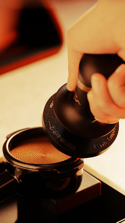 MHW-3BOMBER T6079TS Snake ripple-base tamper beside a concentric coffee imprint; portafilter is illustrative