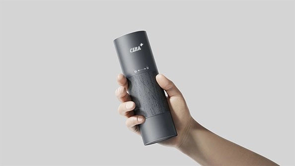 Grey CERA+ CGE01 portable electric grinder held in a hand.