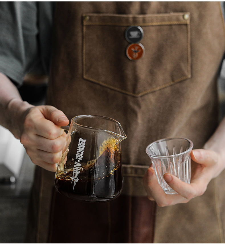 Elf glass server pouring coffee into a Wright glass