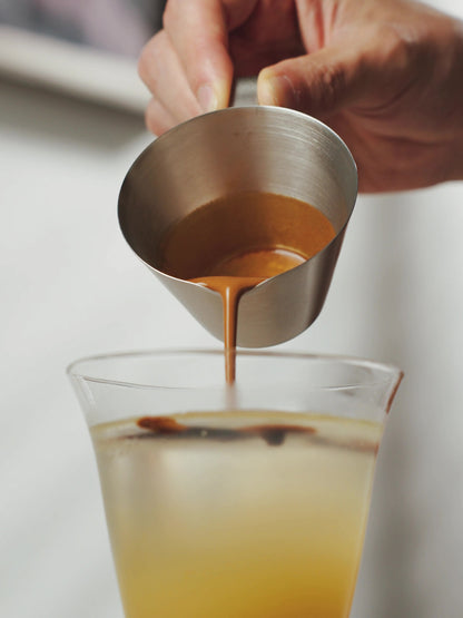 MHW-3BOMBER G5140 satin single-spout measuring cup pouring espresso into a mixed drink