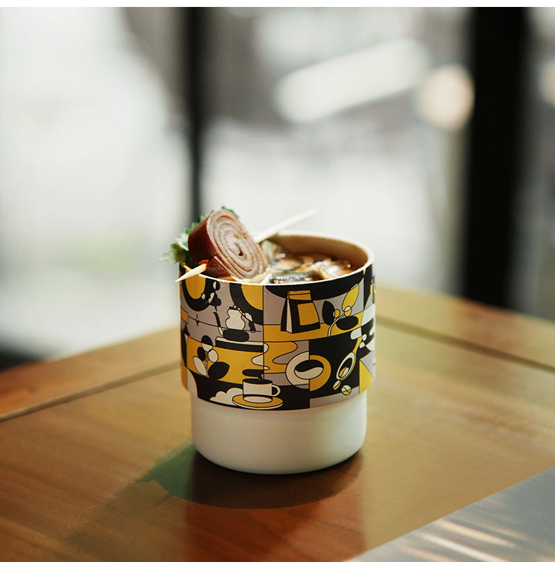MHW-3BOMBER DW6909BY Black Gold Swirl Cup — iced coffee on a wooden table