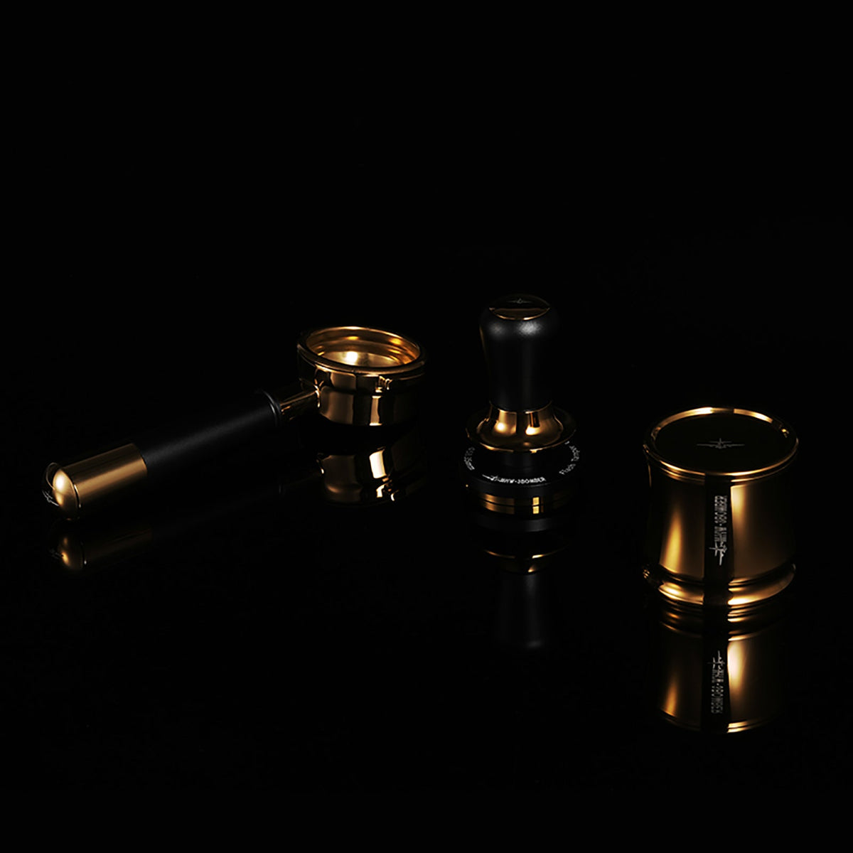 MHW-3BOMBER FlowLight T7032G Black Gold tamper in the centre; portafilter and dosing cup are photographic props, not included