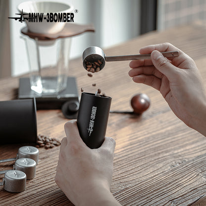 MHW-3BOMBER MS5438 silver-spot long measuring spoon used beside a coffee grinder; grinder is a scene prop