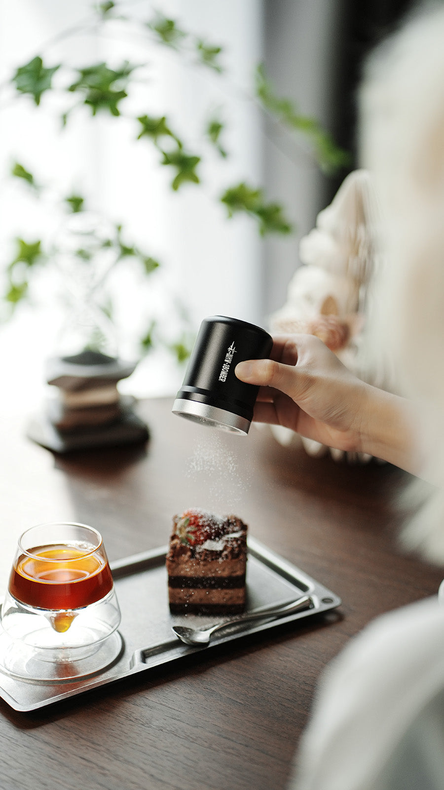 MHW-3BOMBER SP5693B black Shark powder shaker used over a dessert; food, tray and cup are scene props