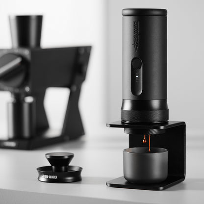 MHW-3BOMBER CM6954 X-press58 brewing on a tabletop; grinder and background equipment are scene props
