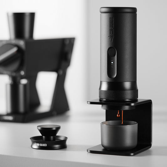 MHW-3BOMBER CM6954 X-press58 brewing on a tabletop; grinder and background equipment are scene props
