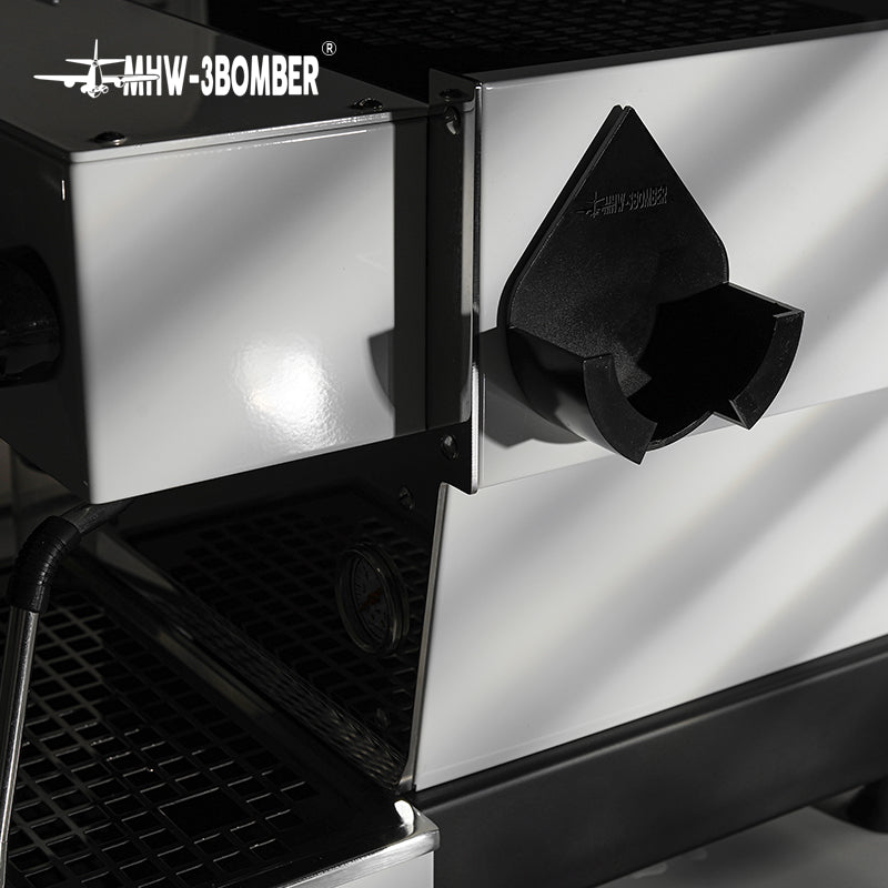 MHW-3BOMBER DPH5713B Black holder mounted beside a coffee machine; machine and portafilter not included