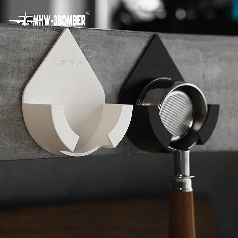 MHW-3BOMBER Black and White DPH holders on a concrete surface, Black in use; portafilter not included