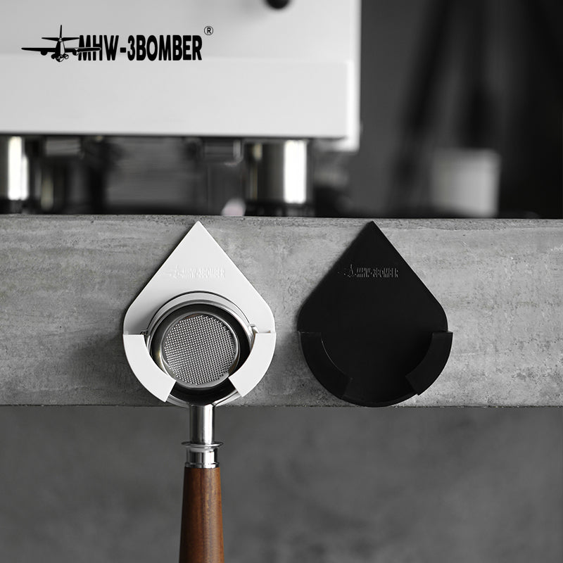 MHW-3BOMBER Black and White DPH holders on a concrete surface, Black empty; portafilter not included