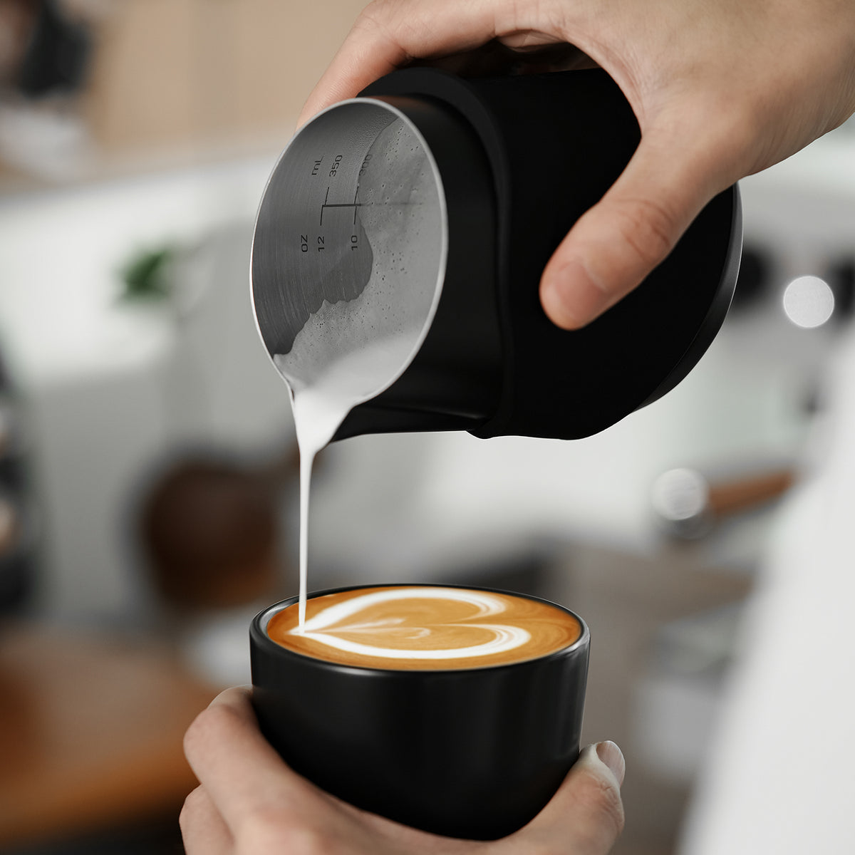 P6513B black handleless pitcher — pouring view