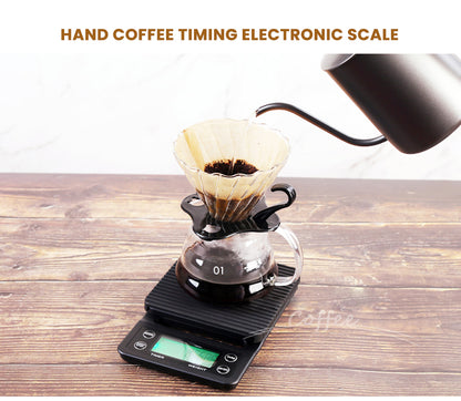 HiBREW black four-button green-LCD timer coffee scale — pour-over demonstration on wooden table. Kettle, dripper, server, filters and coffee are demonstration props, not included.