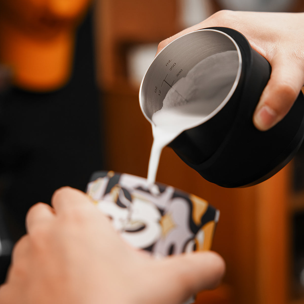 P6513B black GT handleless 400 ml milk pitcher — pouring into an illustrated cup. Cups and other scene items are not included.