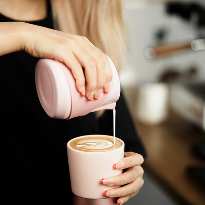 P6514P pink GT handleless 400 ml milk pitcher — barista pouring view. Cups and other scene items are not included.