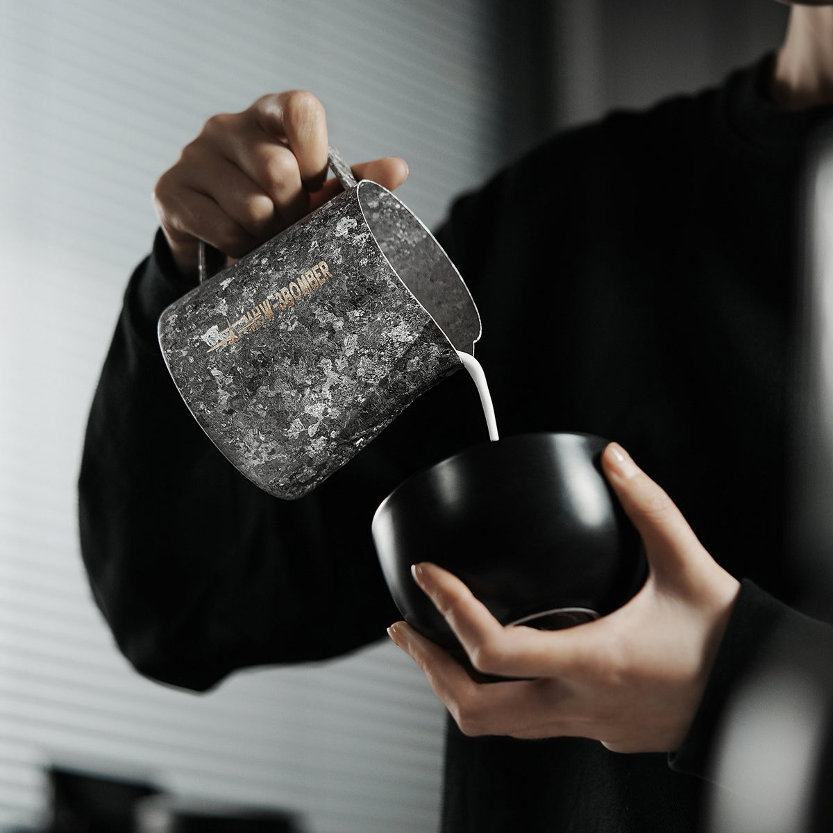P6634 Silver Armour Titanium series 600 ml milk pitcher — pouring from a side angle. Cups and scene items are not included.