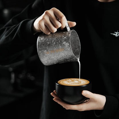 P6634 Silver Armour Titanium series 600 ml milk pitcher — pouring above a black cup. Cups and scene items are not included.