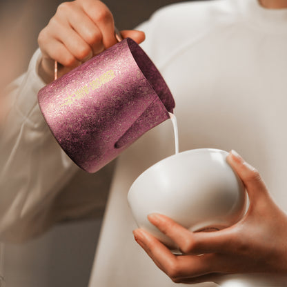P6635R Spark Titanium series 600 ml milk pitcher — close-up pouring into a white cup. Cups and scene items are not included.