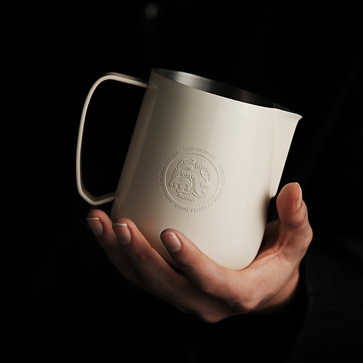 P6654W matte beige white FF 650 ml milk pitcher — hand-held front view. Cups and other scene items are not included.