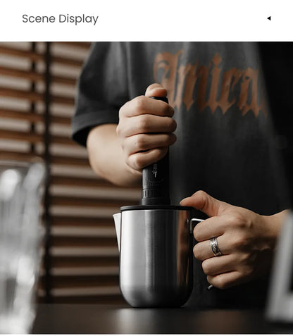 Magician open-handle pitcher in use with a separate frother; frother not included