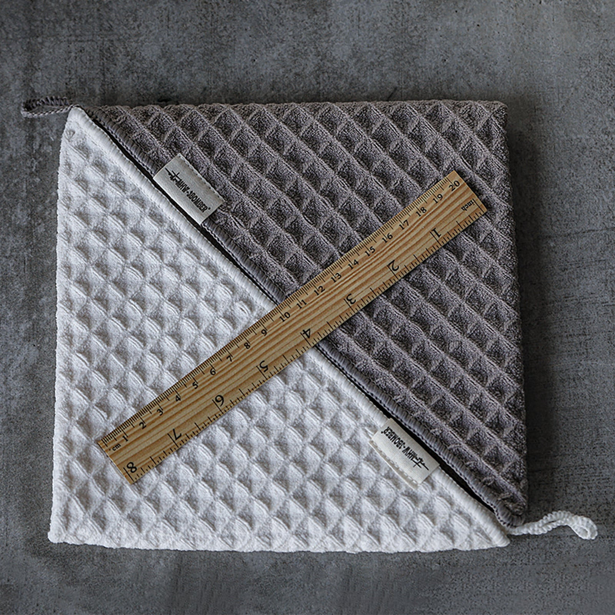 MHW-3BOMBER dark-grey and beige-white square waffle towels beside a ruler; color comparison, one selected towel per SKU.