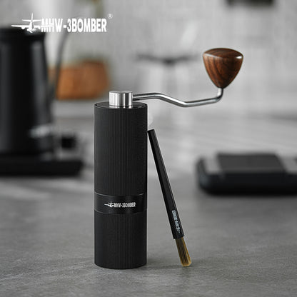 MHW-3BOMBER B5525B dark-bristle black ABS brush leaning beside a grinder; grinder is a scene prop