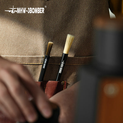 MHW-3BOMBER B5525B dark-bristle ABS brush shown with the B5337B aluminium comparison brush in an apron pocket; comparison brush and apron not included