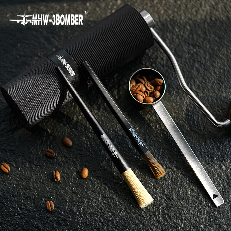 MHW-3BOMBER B5525B dark-bristle ABS brush in a flat lay beside the B5337B aluminium comparison brush and a grinder; comparison brush and grinder not included