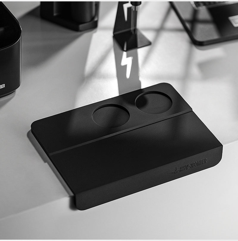 MHW-3BOMBER SP5309B black B-style tamping mat placed on a counter edge