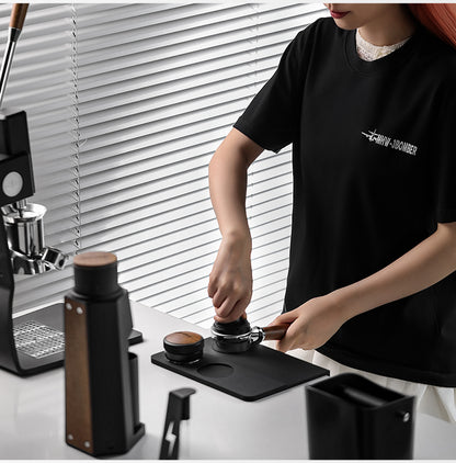 MHW-3BOMBER SP5309B black B-style mat in a barista preparation setup