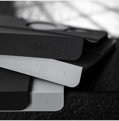 MHW-3BOMBER SP5309B black B-style mat stacked above a grey comparison mat, grey mat not included