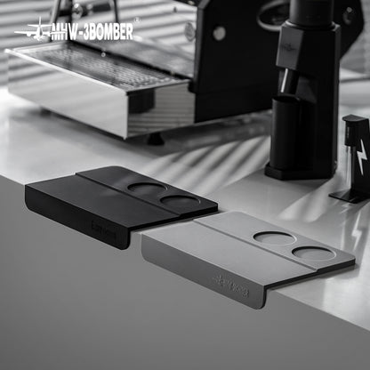 MHW-3BOMBER SP5309B black B-style mat beside a grey comparison mat and espresso equipment, props not included