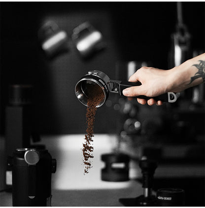 MHW-3BOMBER T5830 dosing ring on a portafilter while excess grounds are tipped out