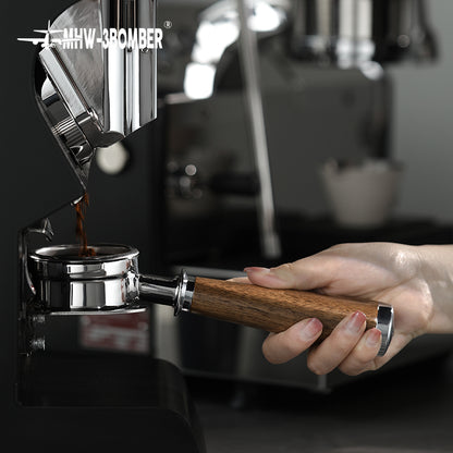 BP6083L walnut bottomless portafilter held at a compatible grouphead before locking in; machine is not included; confirm exact grouphead fit before ordering.