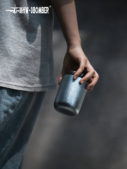 MHW-3BOMBER Blue Titanium Cup carried by hand outdoors