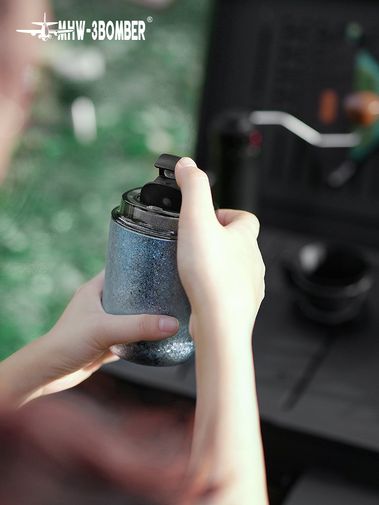MHW-3BOMBER Blue Titanium Cup held in both hands