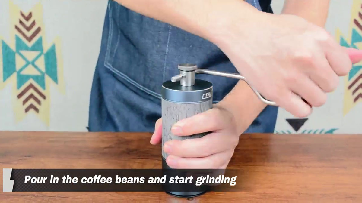 Hand grinding coffee with the CERA+ CG01 Space Grey manual coffee grinder