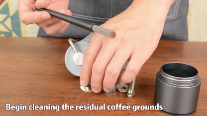 Brushing the disassembled burr components of the CERA+ CG01 manual coffee grinder