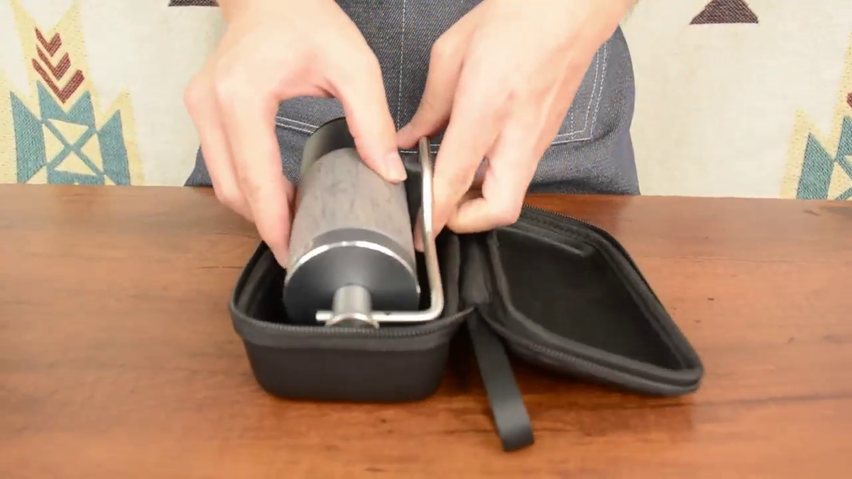 Placing the CERA+ CG01 Space Grey manual coffee grinder in its travel case