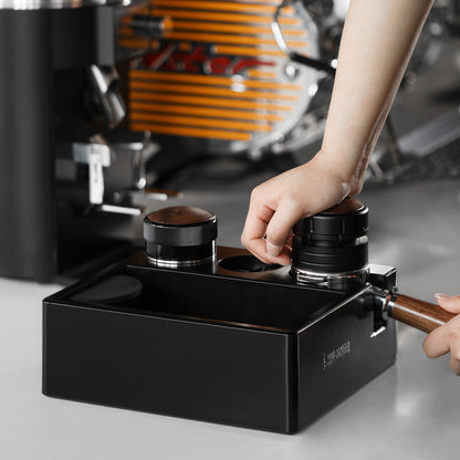 MHW-3BOMBER CH6625 in a coffee-preparation scene with a hand using a distributor; pictured portafilter, tampers and other tools are not included.