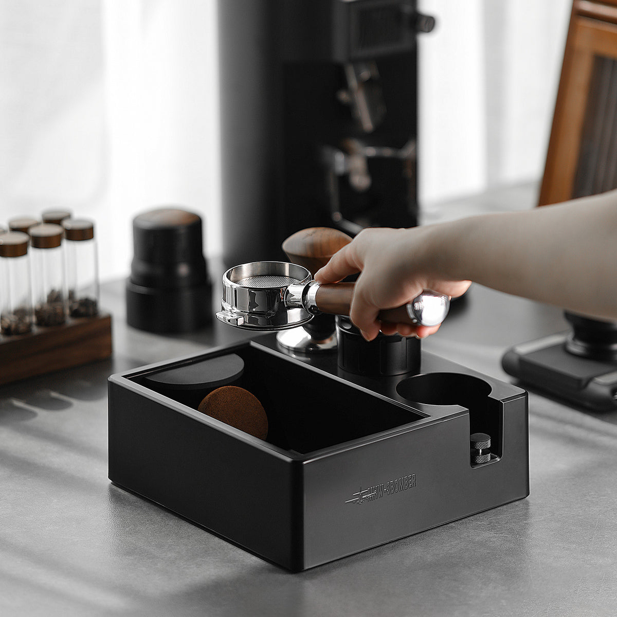 MHW-3BOMBER CH6625 being used to knock coffee grounds into its bin; pictured portafilter, tampers and other tools are not included.