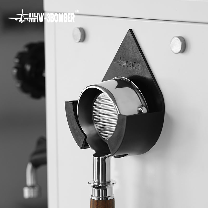 DPH5713B Black droplet holder with bottomless portafilter on a white machine panel; machine and portafilter are display props