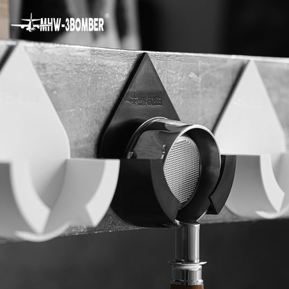 DPH5713B Black droplet holder in use on concrete wall, flanked by White family holders; White holders and portafilter not included