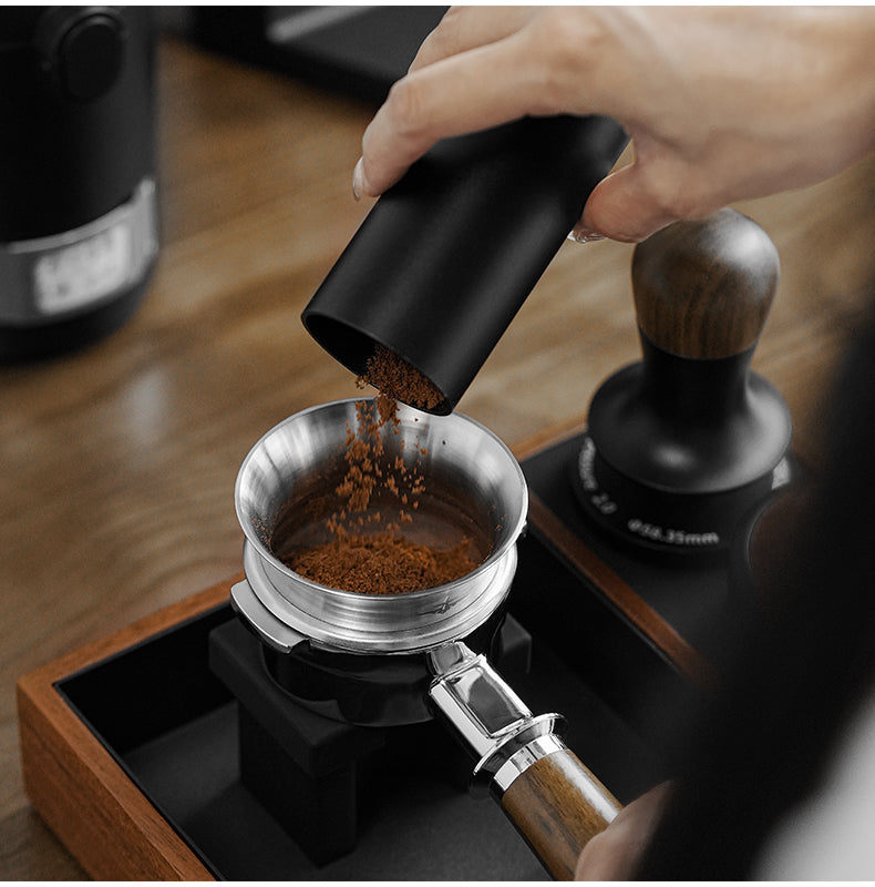 MHW-3BOMBER coffee poured through a silver steel ring from a separate dosing cup